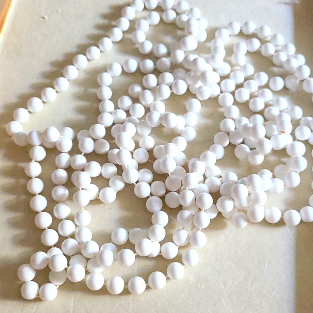 A very long white necklace